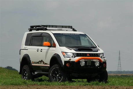 Delica D5 lift kit for enhanced off-road capability on grassy terrain.