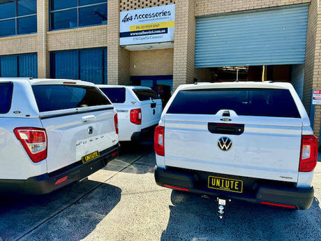 Various canopies for Volkswagen Amarok trucks displayed at an accessory shop, showcasing design options for Amarok owners.
