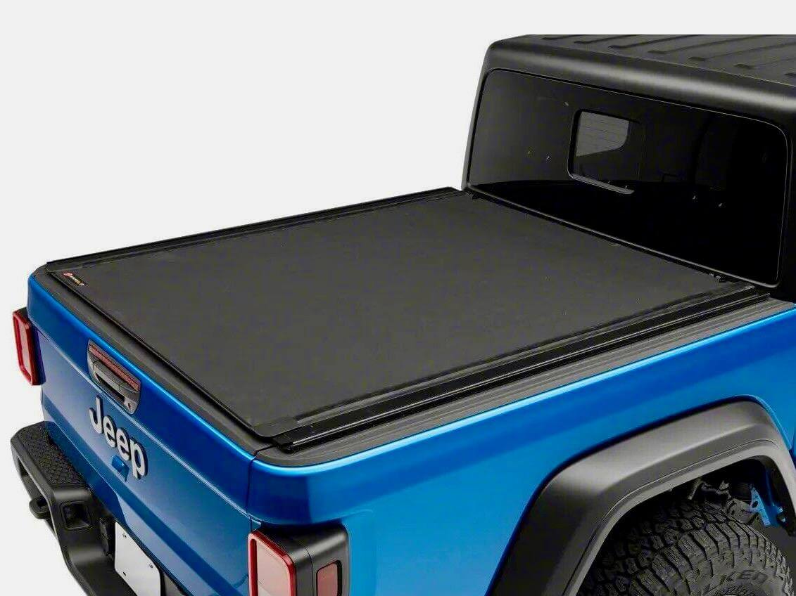 Jeep truck bed with sleek black tonneau cover showcasing secure fit using tonneau cover clips.