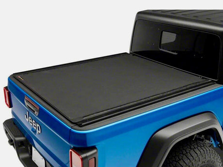 Jeep truck bed with sleek black tonneau cover showcasing secure fit using tonneau cover clips.
