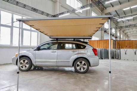 4x4 Awnings: Car sheltered under a large awning in a garage highlighting the benefits of 4x4 awnings for outdoor adventures.