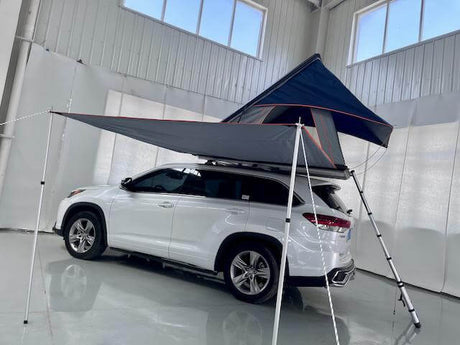 SUV with rooftop tents installed in a garage setting, showcasing a modern camping solution.