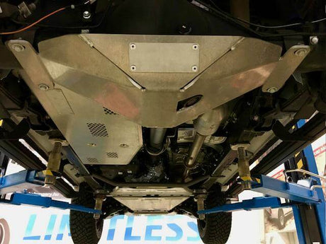 4WD underbody protection showing skid plates installed on the underside of a vehicle on a lift for off-road protection.