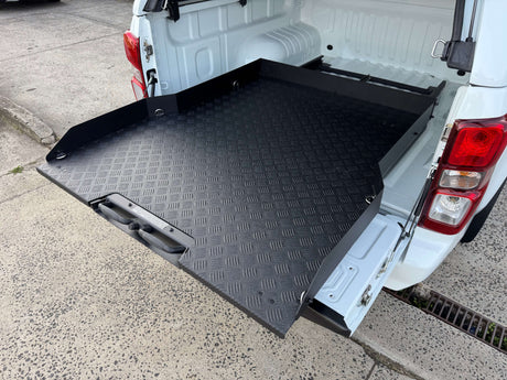 Ute sliding tray extended from a dual cab tub as an alternative to fixed drawer systems