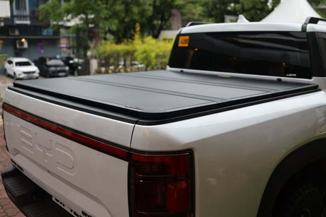 Rear view of a BYD Shark 6 with a black tonneau cover, part of the BYD SHARK 6 Accessories collection at UniUte.