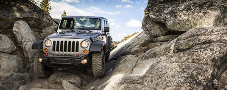 4x4 vehicle navigating rocky terrain, showcasing UNIVERSAL UTE ACCESSORIES for off-road performance improvements