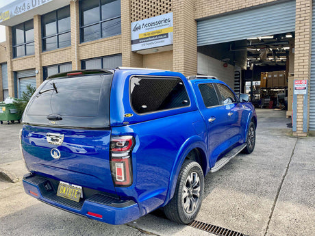 GWM CANNON UTE ACCESSORIES - Blue GWM Cannon Ute with custom canopy parked outside 4x4 accessories store.
