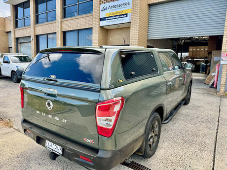 SSANGYONG MUSSO ACCESSORIES showcased on a green SsangYong Musso at UniUte store front.