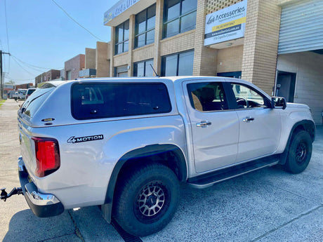White Volkswagen Amarok with canopy parked at UniUte, showcasing Volkswagen Amarok accessories.