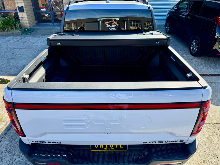 BYD Shark 6 hard lid tri-fold cover on 2025 model truck bed, showcasing style and security enhancements.