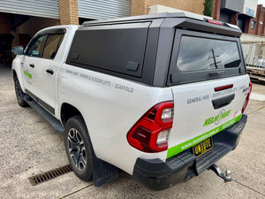Stainless steel canopy on Toyota Hilux — close-up of the brushed finish and weather seals