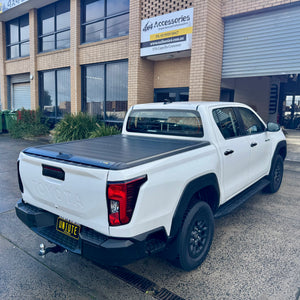 UniUte manual roller shutter on Toyota Hilux N90 — parked outdoors rear view