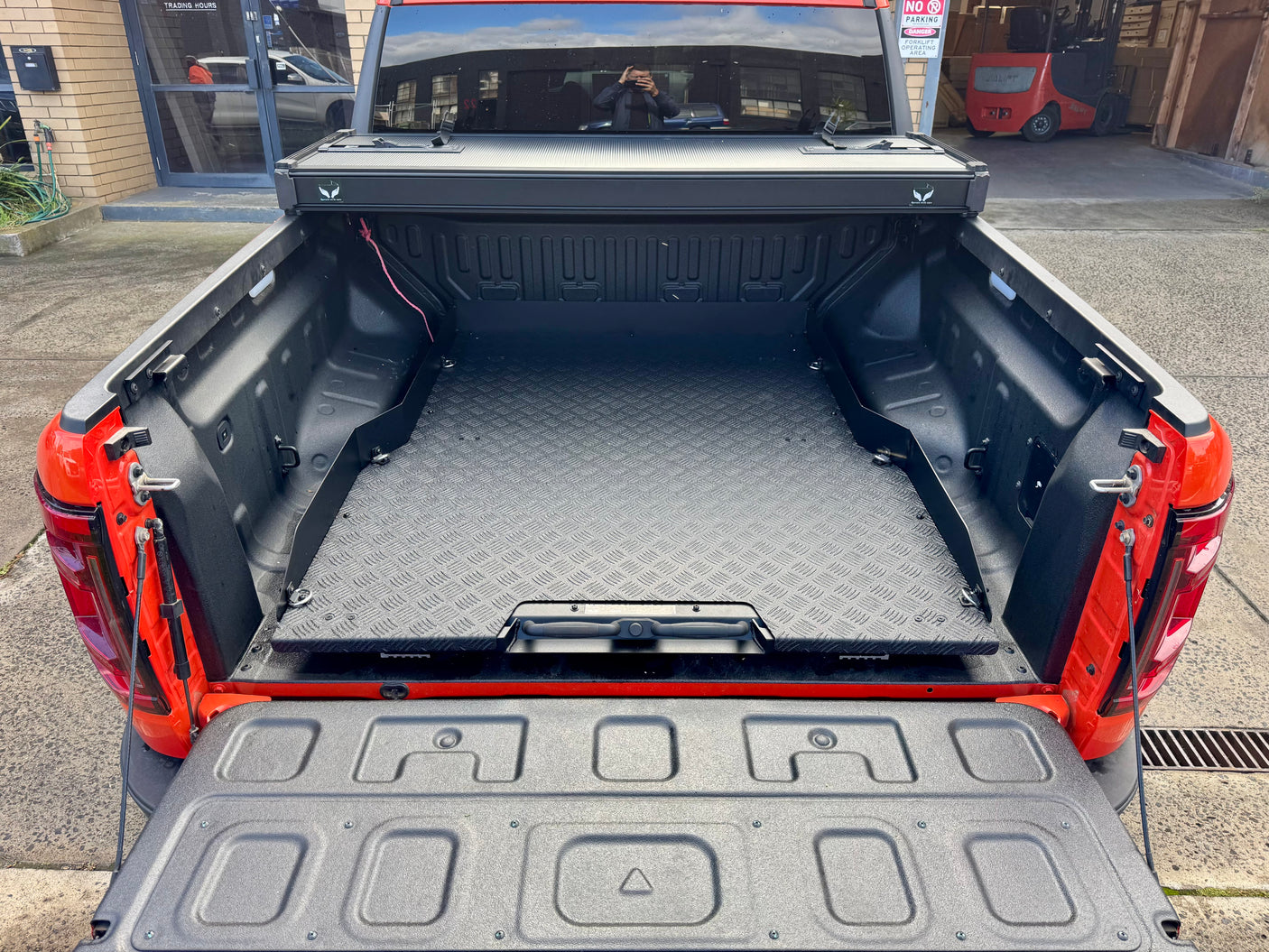 Sliding Tray for BYD Shark 6 in red ute, showcasing cargo access and hybrid-ready design.