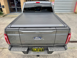 Ford F-150 5'5" bed electric roller shutter — rolled back into the canister at the bulkhead