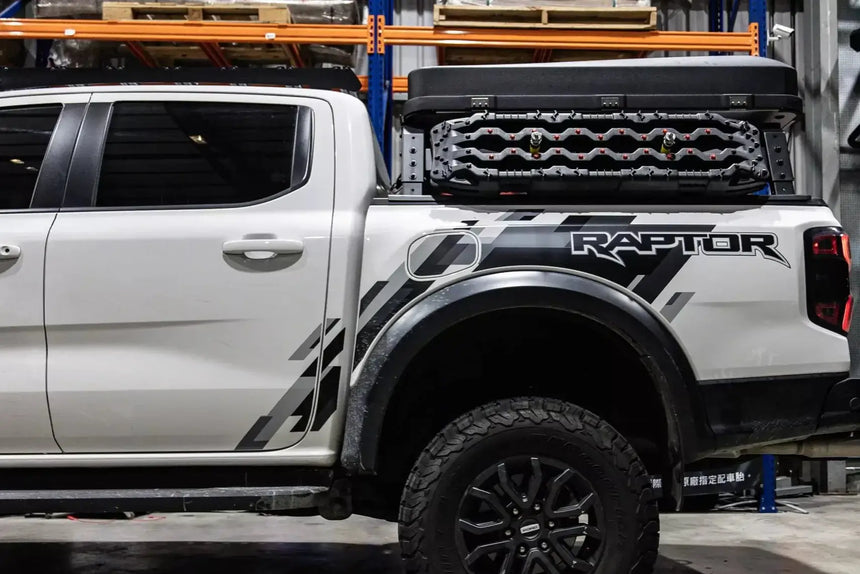 Tub rack carrier on pickup truck loaded with gear and accessories outdoors.