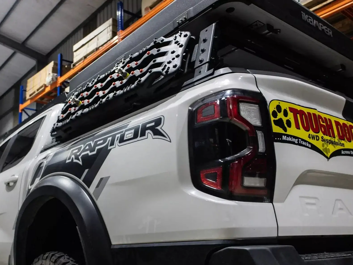 Truck with tub rack carrying gear, featuring the Universal Utility Multifunction Rack Carrier Cage for versatile hauling.