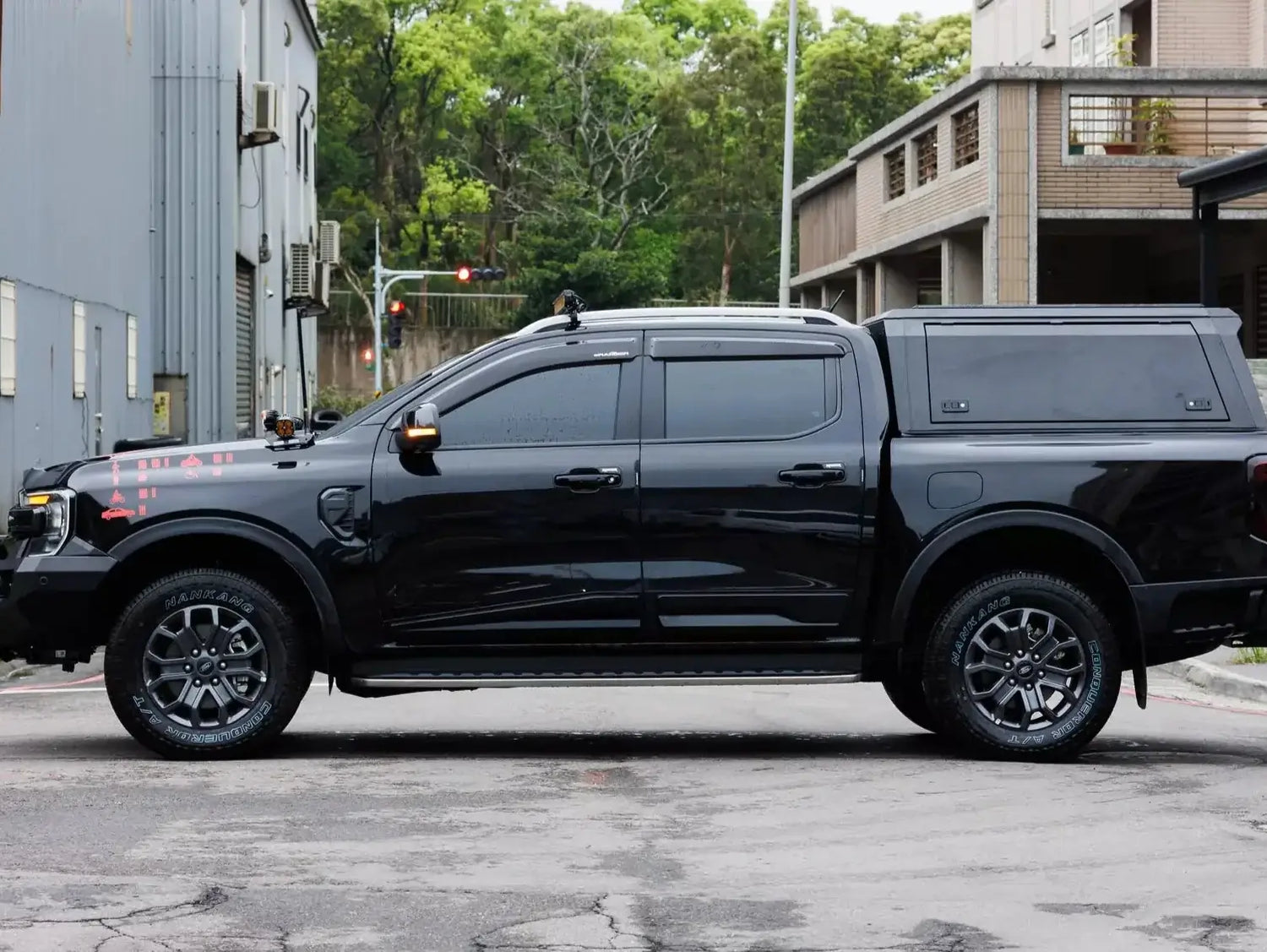Black Ford Ranger with stainless steel canopy ford ranger NextGen 2023+ parked outside.