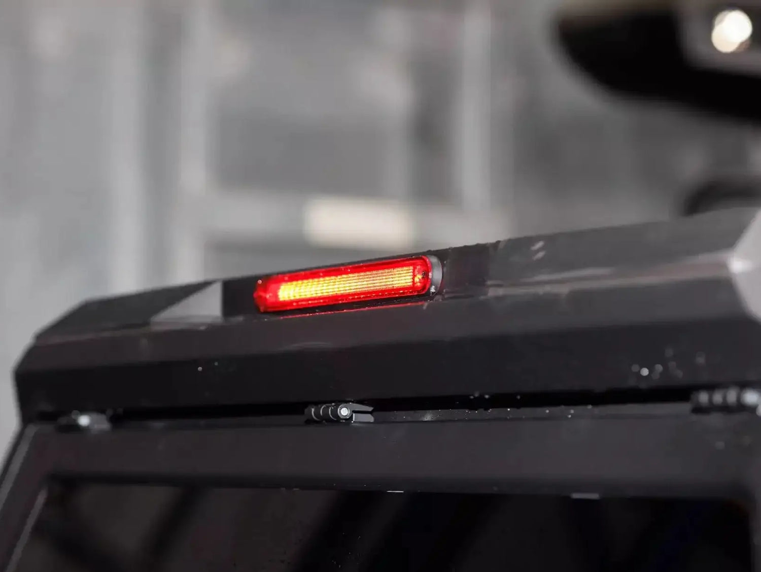 Close-up of stainless steel canopy Ford Ranger NextGen 2023+ with red brake light. High-quality ute accessory. Canopy ford ranger.