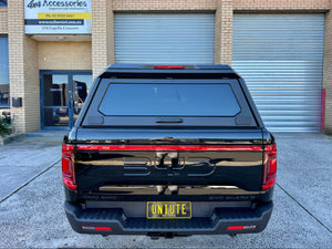 UniUte stainless steel canopy on BYD Shark 6 — rear three-quarter view closed