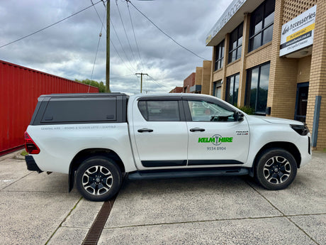 Toyota Hilux stainless steel canopy — rear door open showing interior tub storage