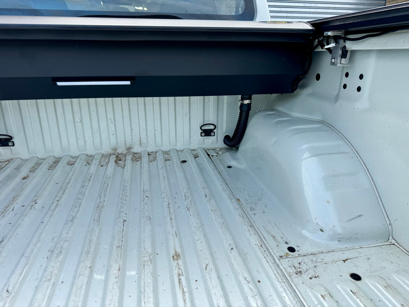 Electric roller shutter for Navara NP300 — half-open position showing motorised operation