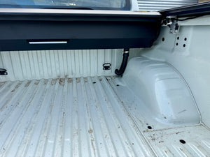 Electric roller shutter for Navara NP300 — half-open position showing motorised operation
