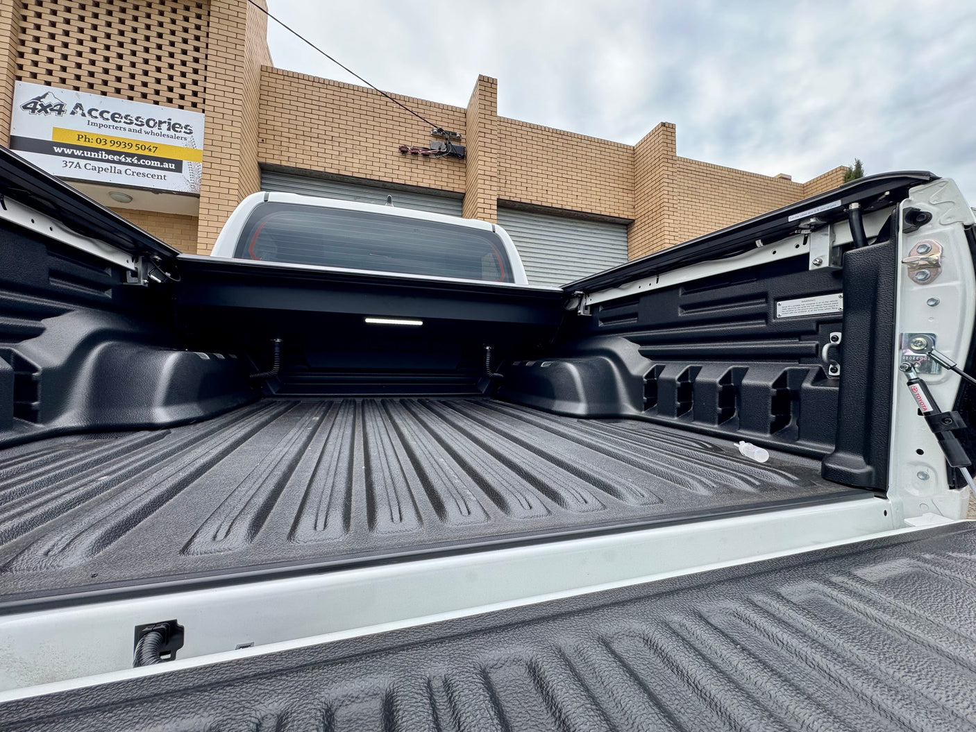 Toyota Hilux N80 N90 electric roller shutter — detail of the canister and mounting rails