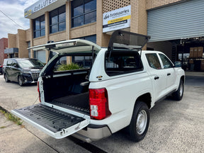 Nissan Navara D27 canopy — rear door open showing interior tub storage
