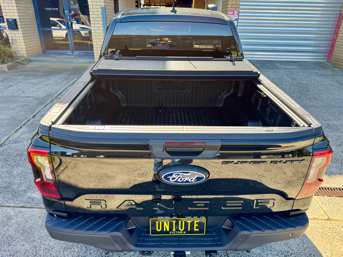 Quad-fold hard lid for Ford Ranger NextGen — panel locking mechanism close-up