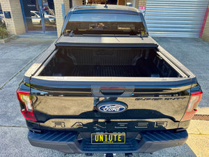 Quad-fold hard lid for Ford Ranger NextGen — panel locking mechanism close-up