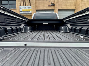 Toyota Hilux N80 N90 roller shutter — control switch and tailgate weather-seal detail
