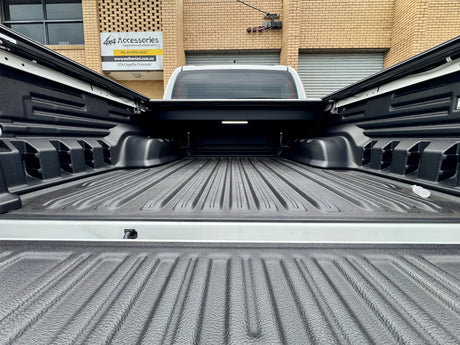 Toyota Hilux N80 N90 roller shutter — control switch and tailgate weather-seal detail