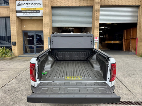 BYD Shark 6 tub cover installed on pickup truck with opened tonneau quad-fold hard lid for 2025 model