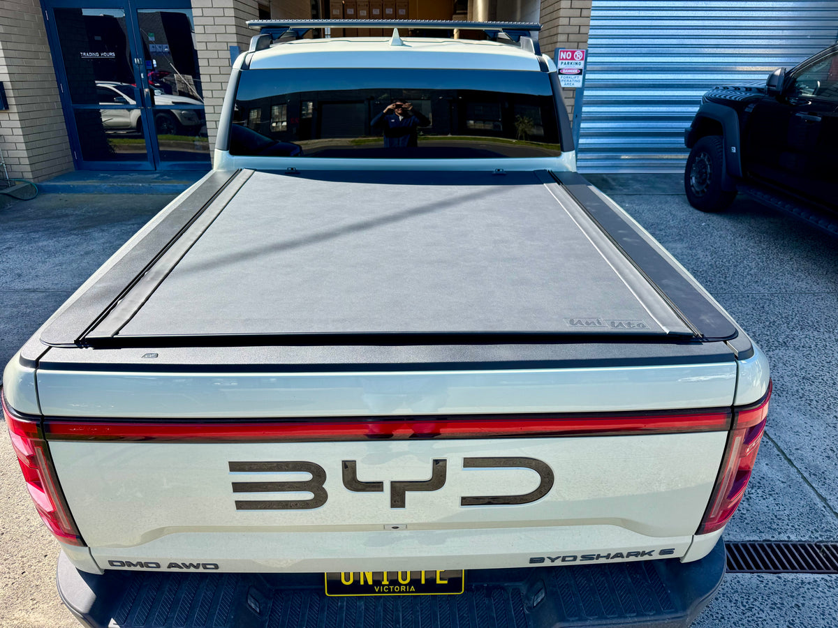 REVOLVER tonneau on BYD Shark 6 — partially rolled showing tub access