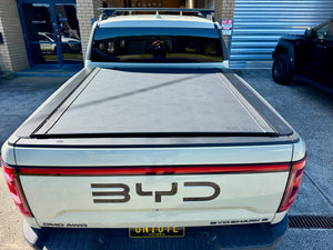 REVOLVER tonneau on BYD Shark 6 — partially rolled showing tub access