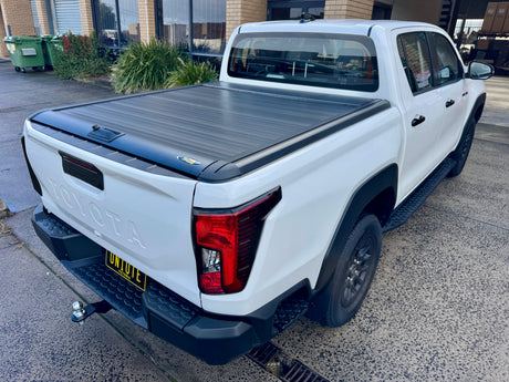 Manual roller shutter fitted to Toyota Hilux N90 2026+ — installed on SR5 rear view | UniUte