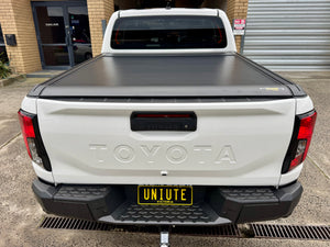 Electric roller shutter on Toyota Hilux N80 N90 — side profile showing low-profile aluminium slats