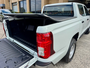Triton MV 2024+ soft tri-fold cover — panel folded showing tub access