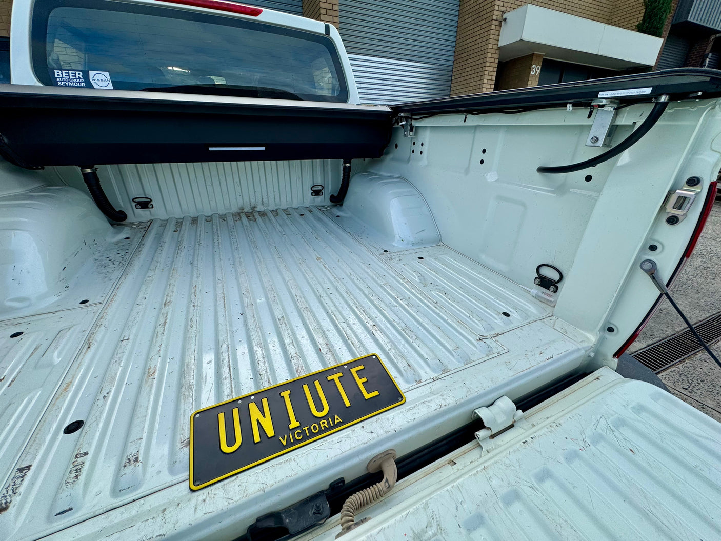 Nissan Navara NP300 roller shutter — control switch and tailgate weather-seal detail