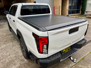 Toyota Hilux N80 N90 roller shutter — rear three-quarter view with the shutter closed