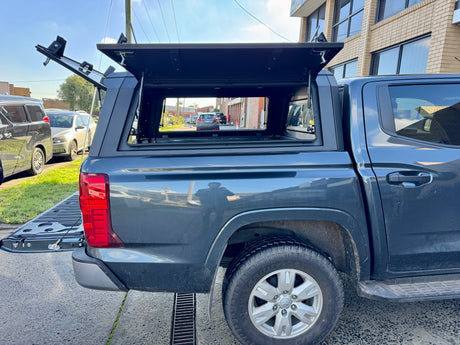 Triton MV stainless steel canopy — rear three-quarter view showing the door and finish