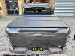 KIA Tasman 2025+ with tri-fold hard lid — rear view showing panel fit