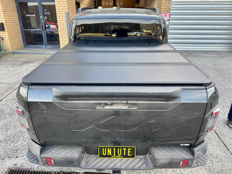KIA Tasman 2025+ with tri-fold hard lid — rear view showing panel fit