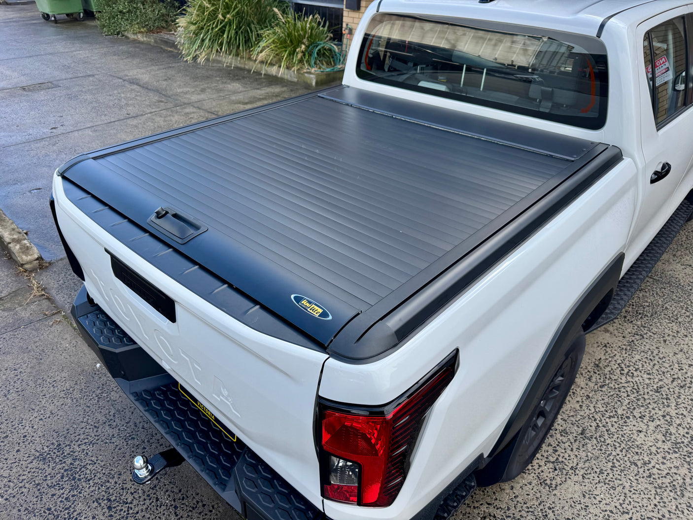 Toyota Hilux N90 2026+ roller shutter — fully closed protecting truck bed cargo