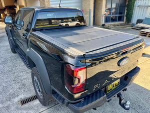 Quad-fold hard lid on Ford Ranger NextGen — all panels folded toward cab