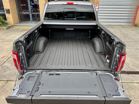 Ford F-150 roller shutter — control switch and tailgate weather-seal detail