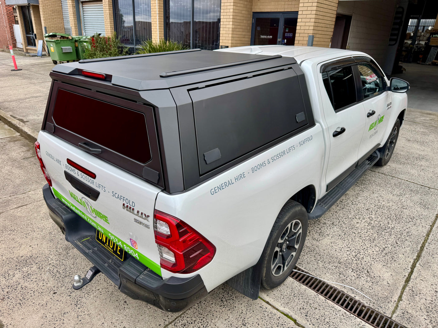 Toyota Hilux 2015–2026 stainless steel canopy — rear three-quarter view showing door and finish