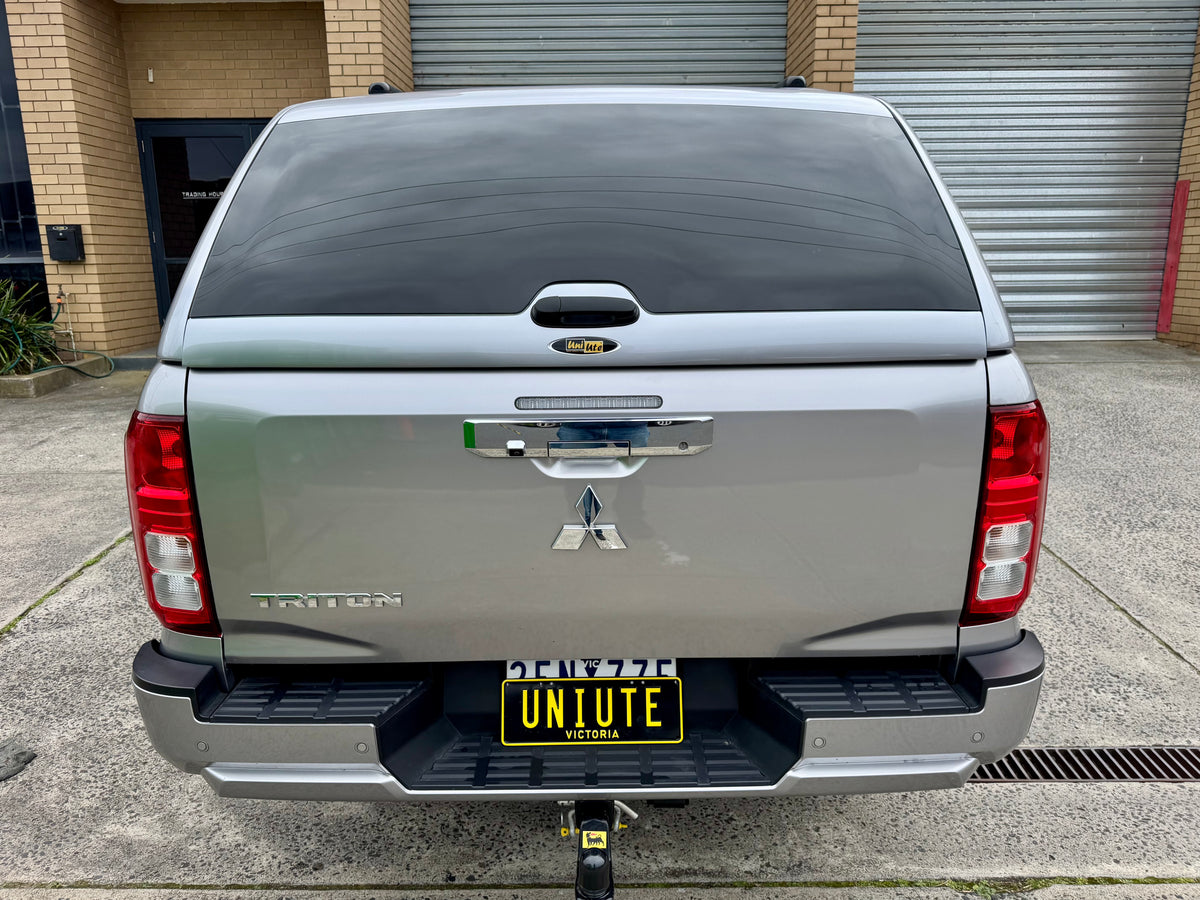 Triton MV fibreglass canopy — rear three-quarter view showing the door and finish