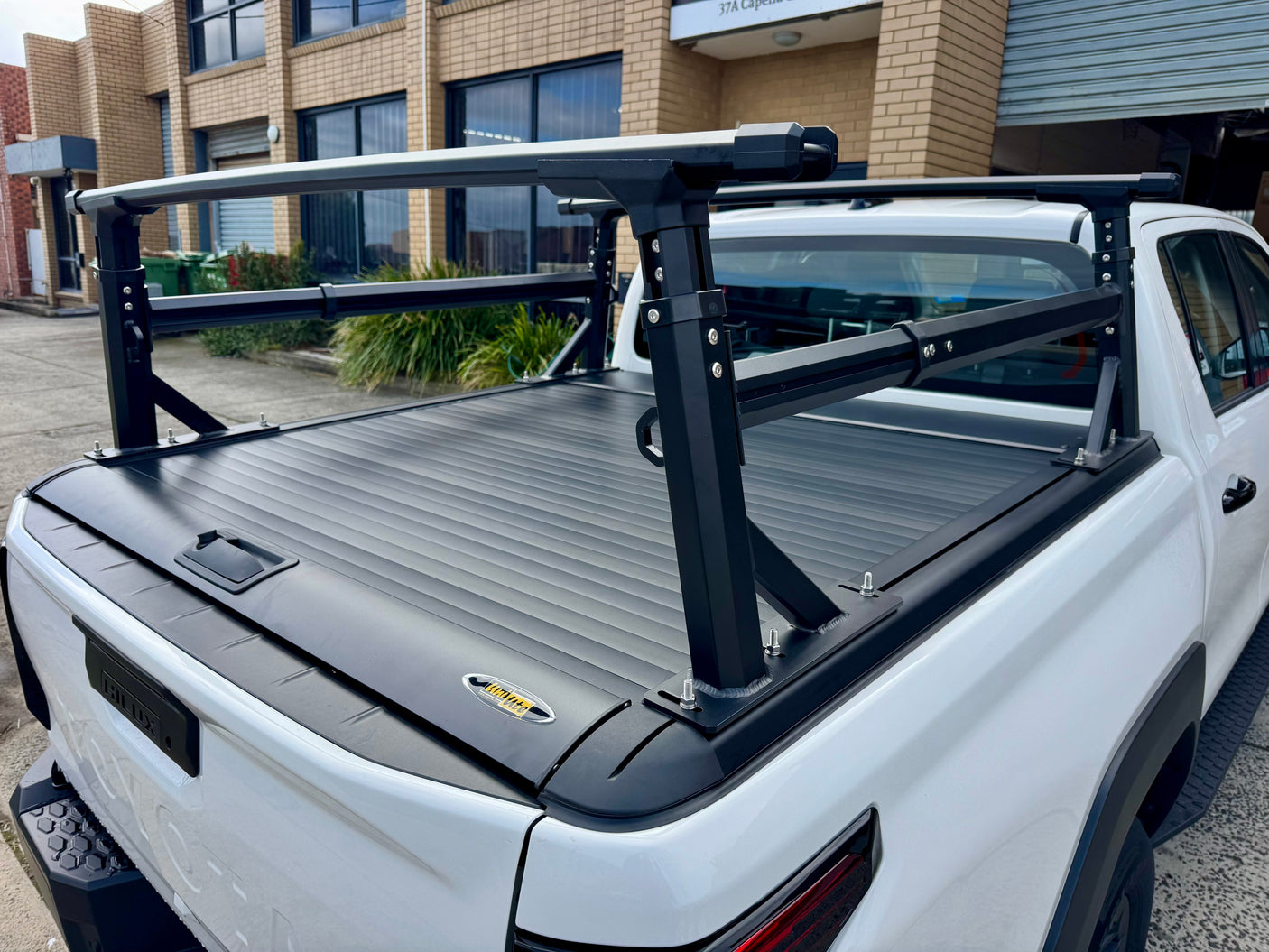 Heavy duty aluminium ladder rack for roller covers — installed on ute showing full rack height | UniUte