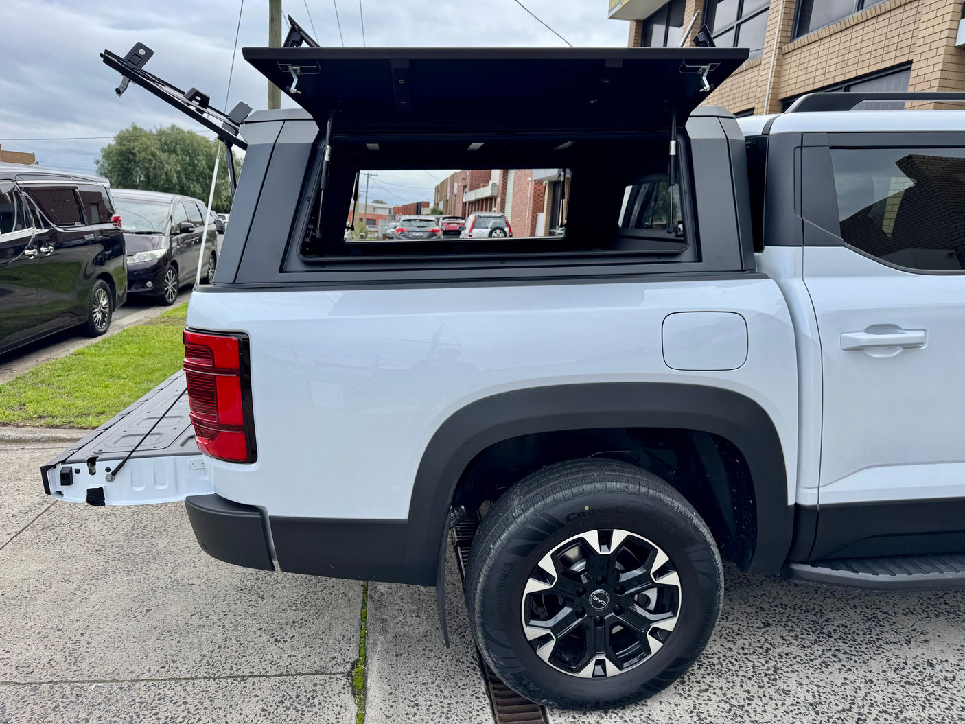 BYD Shark 6 stainless steel canopy — rear three-quarter view parked outdoors